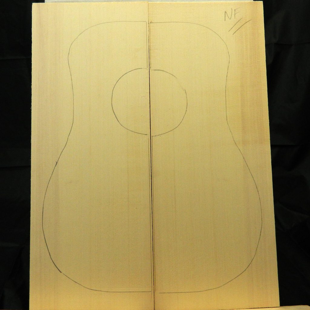 Sitka Spruce Dreadnought Guitar tops with guitar body outline and sound hole marked.