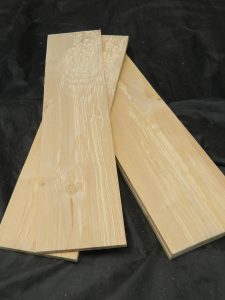 Three red alder grilling boards with natural grain patterns and wavy figure detail.