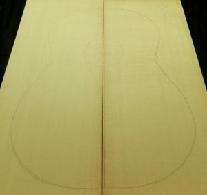 Classical Non-figured Sitka spruce bookmatched soundboard with classical guitar body outline.