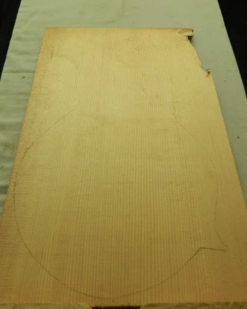 Rough-sawn 1-Piece Violin Non-figured Sitka wood blank with pencil instrument outline and vertical grain.