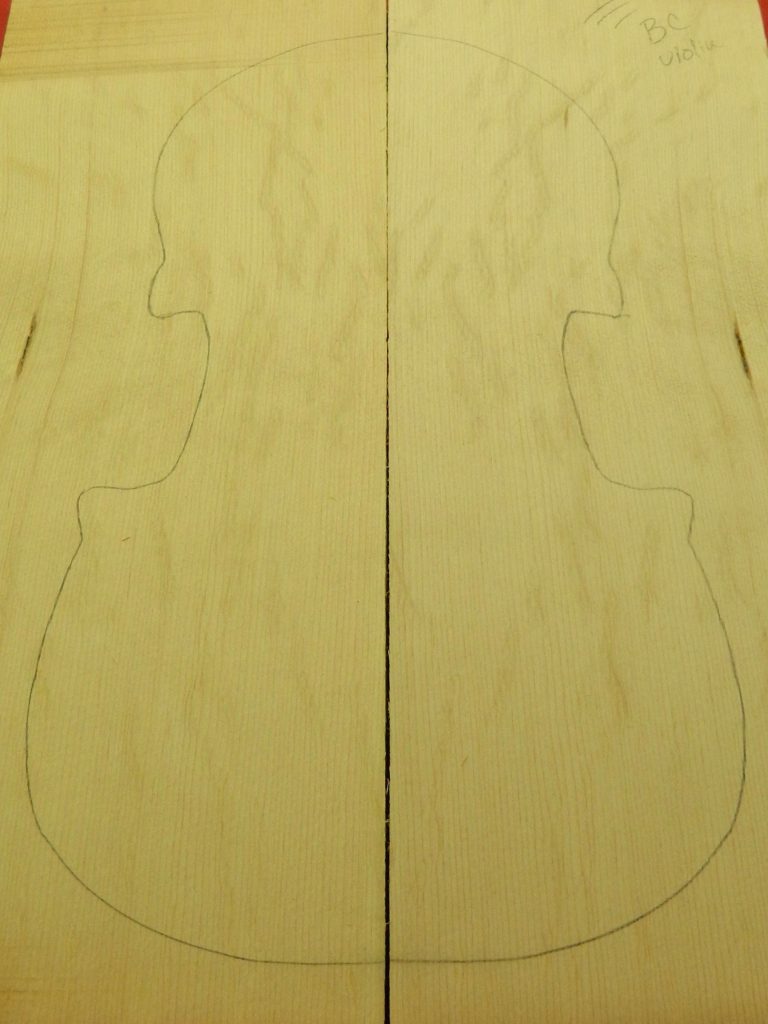 Sitka Bearclaw Violin Wedge with pencil violin outline and bearclaw grain pattern.