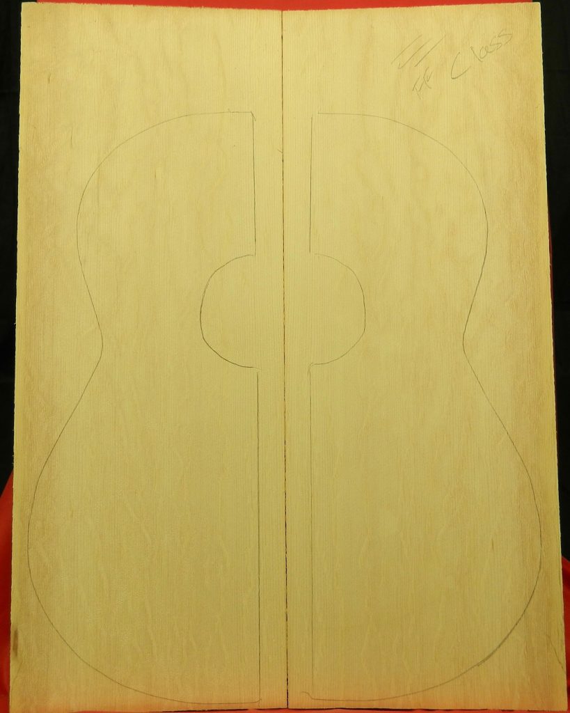 AAA Bear Claw Sitka Spruce bookmatched planks with pencil-outlined classical guitar body.