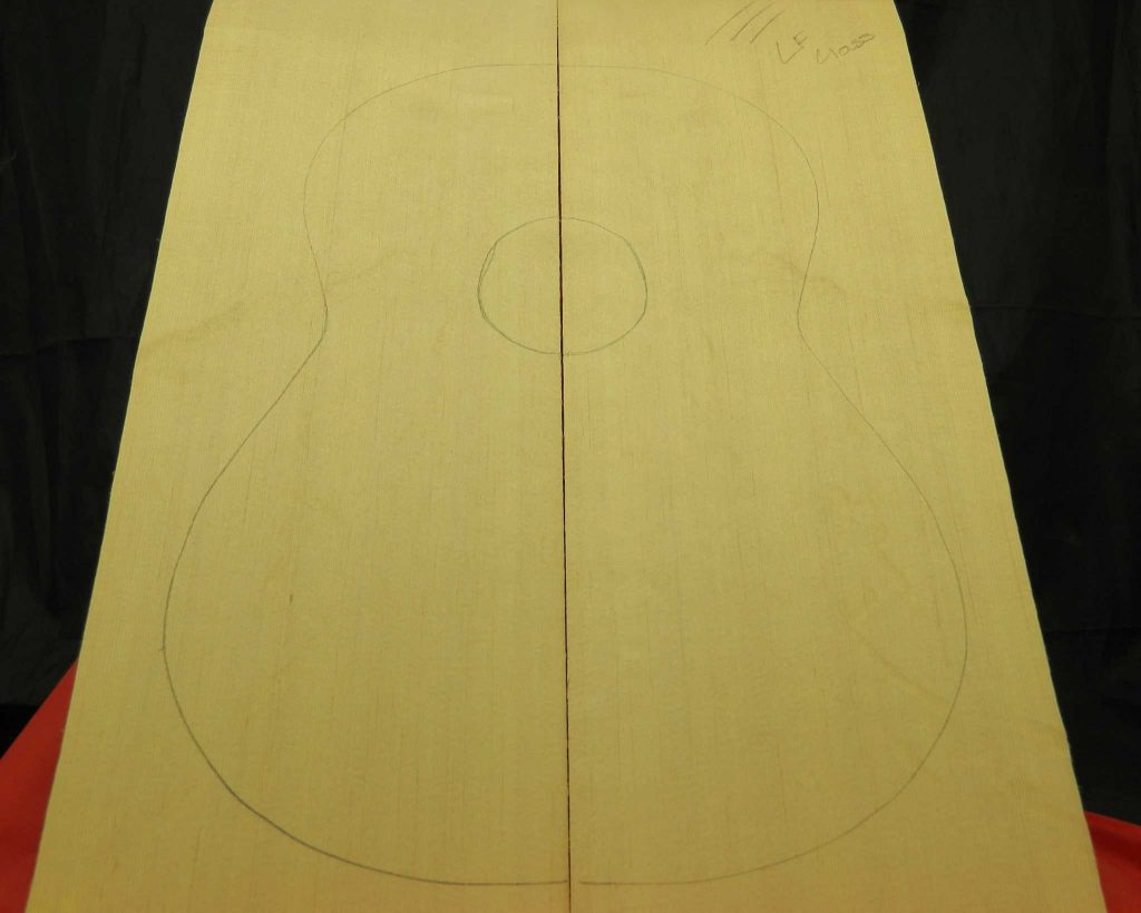 AAA Figured BearClaw Sitka Spruce book-matched guitar top with pencil outline for classical guitar body.