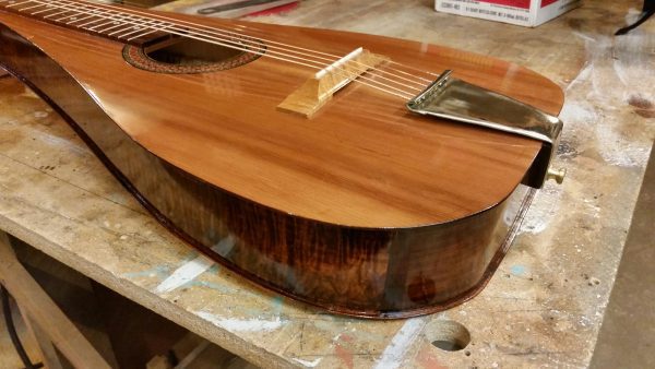 Float Log Weissenborn stringed instrument on workbench showing finished wood grain and construction quality.