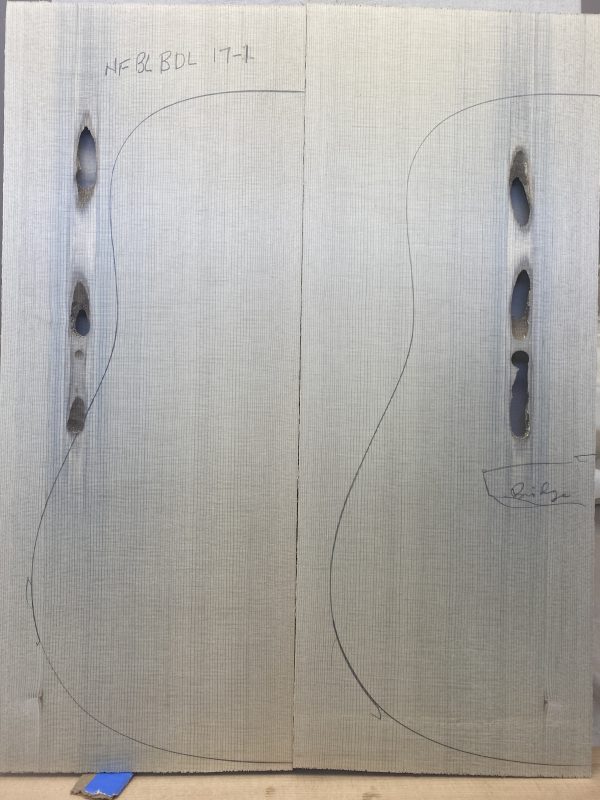 Pale wood planks with guitar outlines and pre-drilled holes for Denim Blue Guitar Tops preparation.
