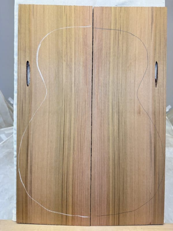 Red Cedar Classical Size guitar soundboard panels with classical body outline and sound holes.